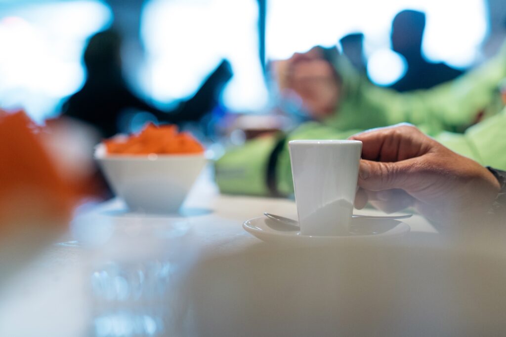 Hand holding mug in cafe during peaceful morning mindfulness routine