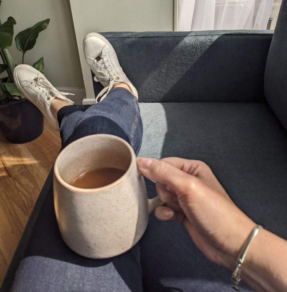Close up of hands holding cup of coffee