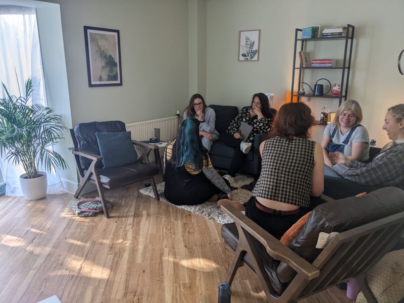 Professionals and couples discussing mental health support during therapy session